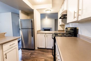 a kitchen with stainless steel appliances and white cabinets